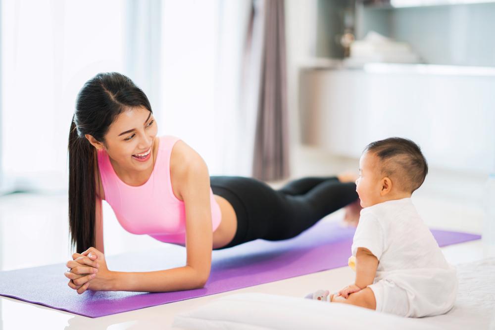 mom and baby doing yoga plank pose