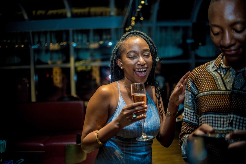 woman holding flute of champagne in club