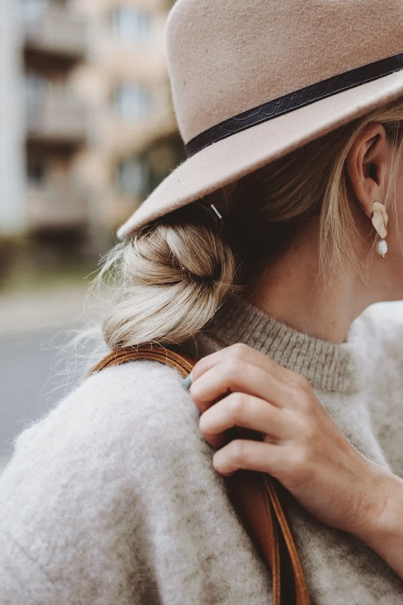 woman wearing beige felt hat with blonde hair