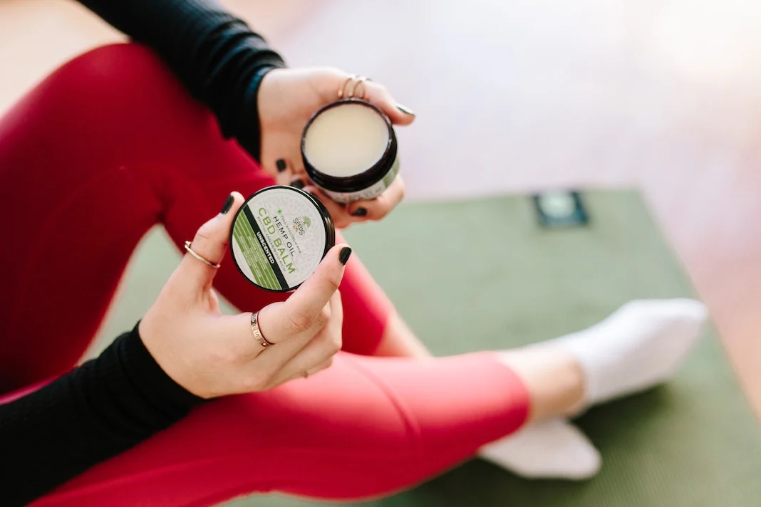 woman applying life of seed cbd balm