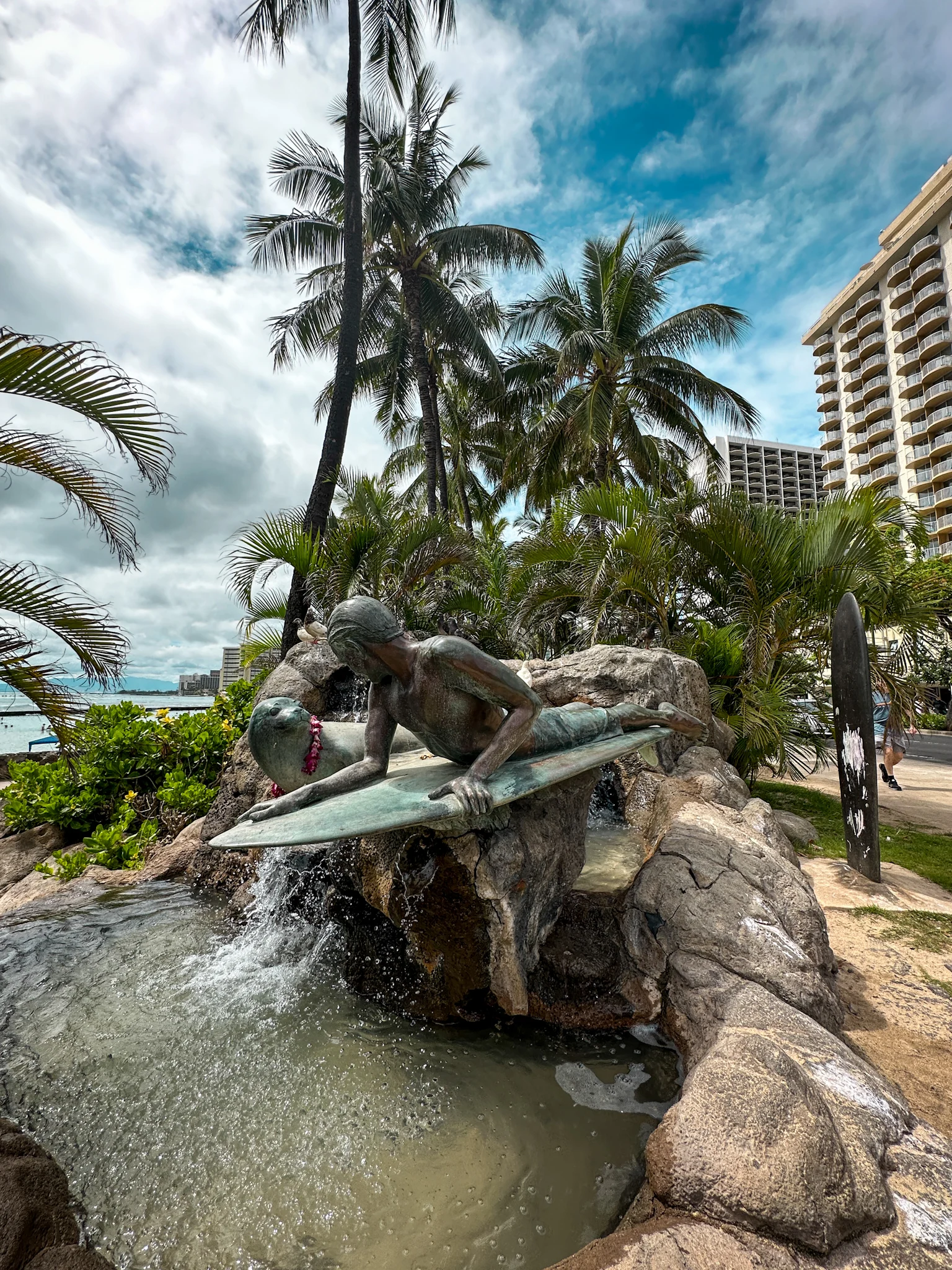 Surfer boy and seal statue in waikiki honolulu oahu