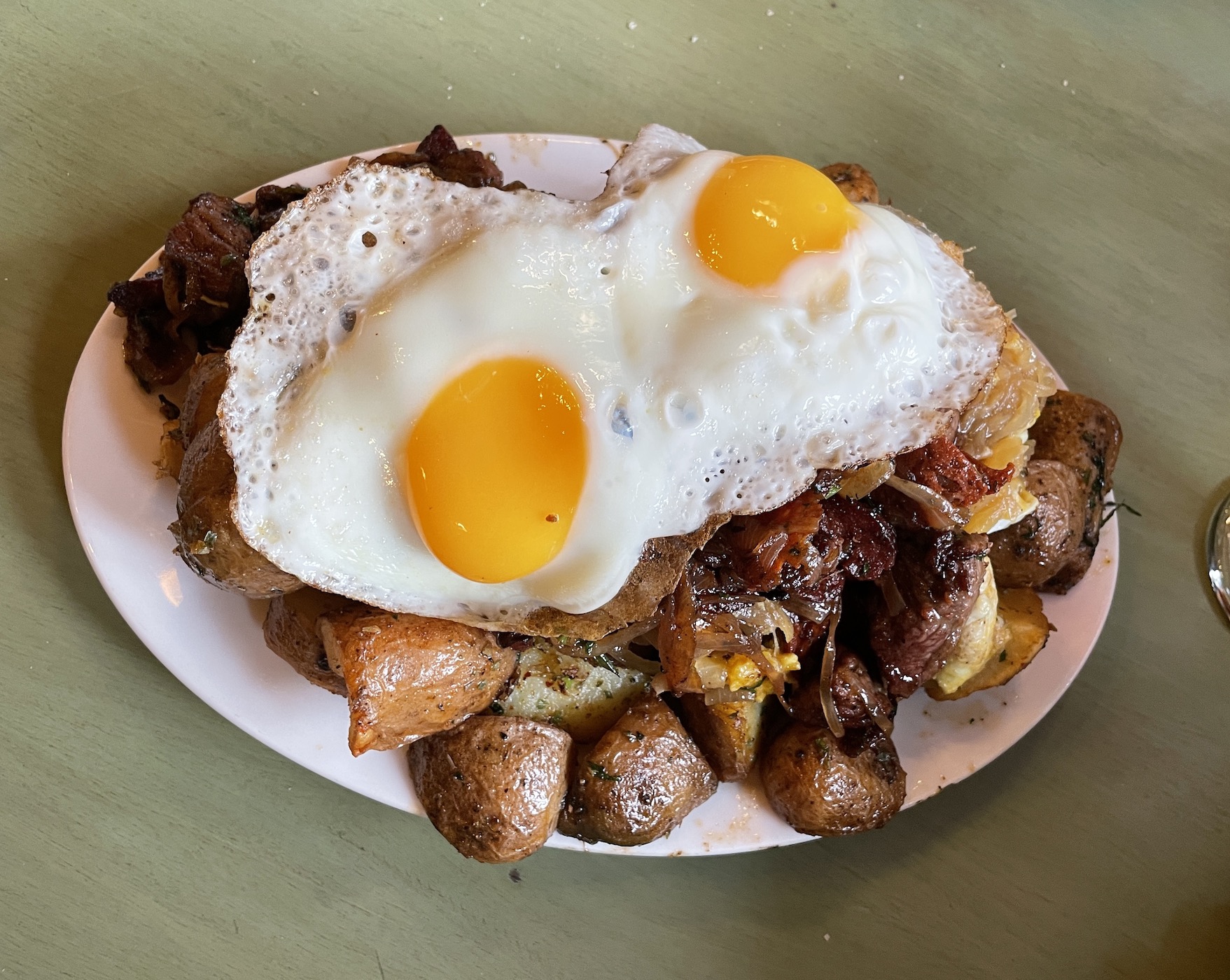 Chilean food Chorillanas beef potatoe and fried egg dish