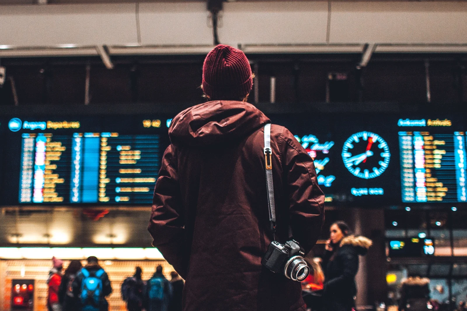 man waiting in airport terminal for flight