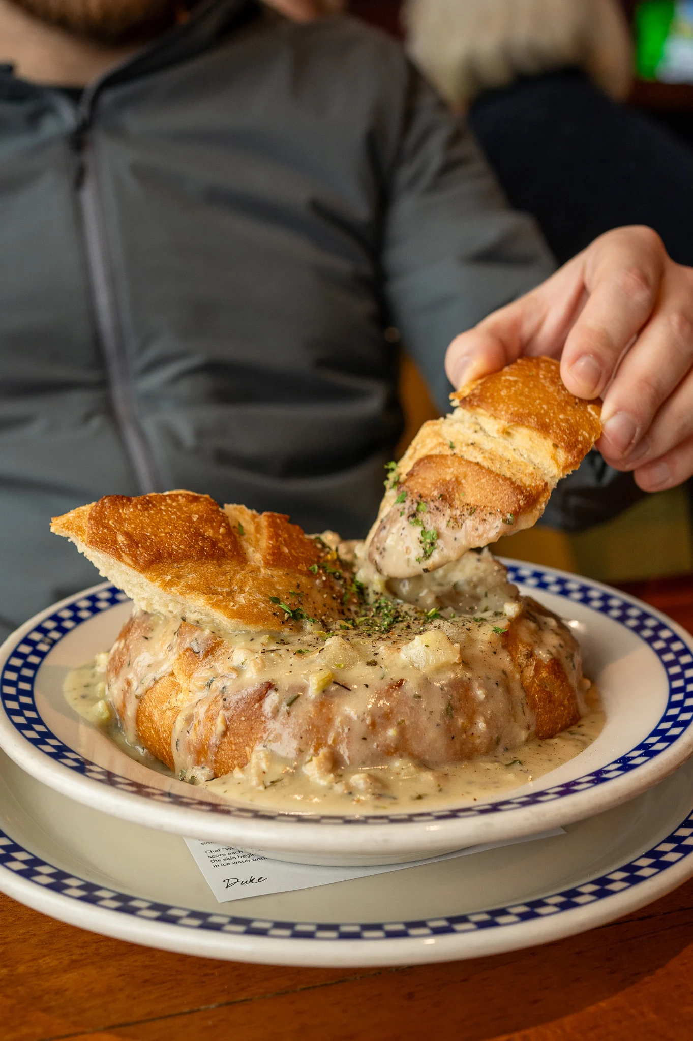 Dukes Seafood Clam Chowder in sourdough bowl Alki Beach West Seattle