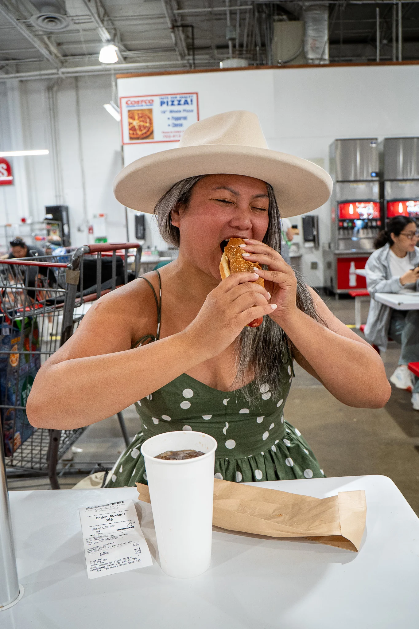 costco photoshoot eating hot dog in food court